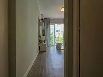 an open hallway with a room with a table and a hallwayngthngthngthngth at Pura Vida Apartment by Hello Homes Sitges in Sitges