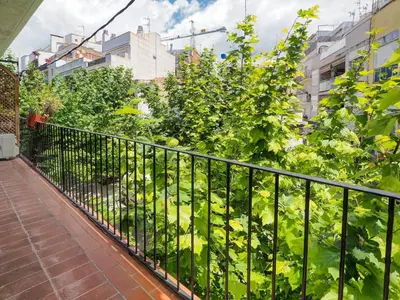a balcony with a fence and some plants at Pura Vida Apartment by Hello Homes Sitges in Sitges