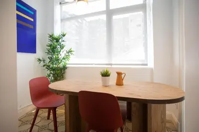 a dining room table with two chairs and a window at Tendency Apartments Miro 8 in Barcelona