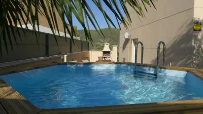 a large blue swimming pool on the side of a building at RACÓ DEL GARRAF Ca la Matilde house BBQ and POOL in Olivella