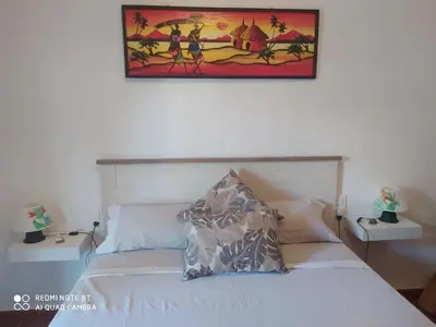 a bedroom with a bed with a picture on the wall at Habitación privada en casa particular, montaña in Olesa de Bonesvalls