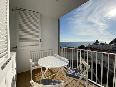 a balcony with a table and chairs and the ocean at Montaber Apartments - Sant Pol de Mar in San Pol de Mar