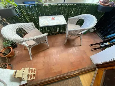 three chairs and a table on a balcony at Pisito bonito y funcional en Pineda De Mar in Pineda de Mar