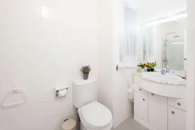 a white bathroom with a toilet and a sink at Llorens Sagrada Familia in Barcelona