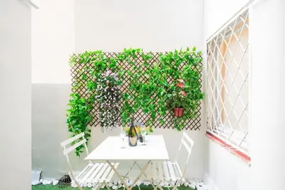a patio with a white table and some plants at Llorens Sagrada Familia in Barcelona