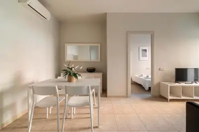a dining room with a white table and chairs at Stay U-nique Apartments Torre Damians in Barcelona