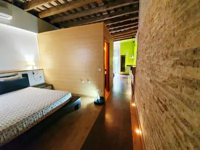 a bedroom with a bed and a brick wall at Apartamento Llibertat centro in Vilanova i la Geltrú
