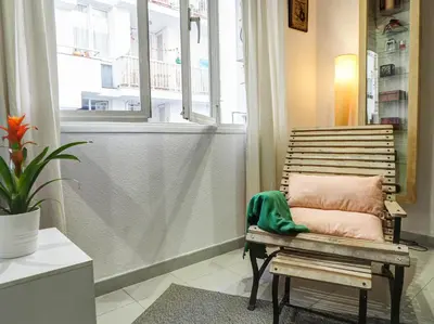 a bench in a room with a window at Sunflower Apartment by Hello Homes Sitges in Sitges