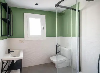 a bathroom with a toilet and a sink at Caliu Apartments Barcelona - Camp Nou in Hospitalet de Llobregat