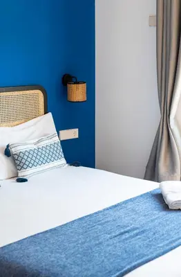 a bed with a laptop sitting on top of it at Caliu Apartments Barcelona - Camp Nou in Hospitalet de Llobregat