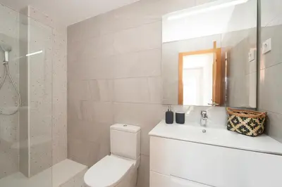 a bathroom with a toilet and a sink and a shower at Casa Natura Gava Beach in Gavà