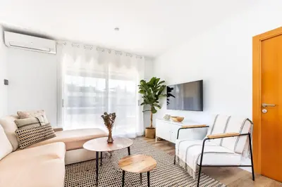 a white living room with a couch and a table at Casa Natura Gava Beach in Gavà
