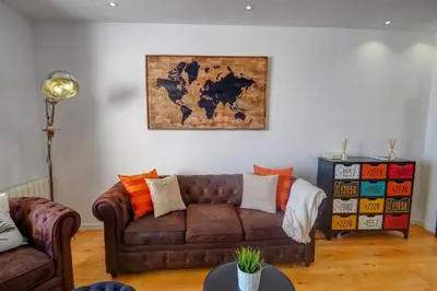 a living room with a couch and a map on the wall at The Moonlight Sea View by Hello Homes Sitges in Sitges