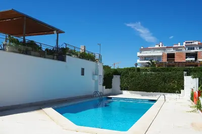 a swimming pool on the side of a building at The Moonlight Sea View by Hello Homes Sitges in Sitges