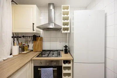 a kitchen with a stove top oven next to a refrigerator at Vintage 3 Bdr Apartment in Esplugues de Llobregat