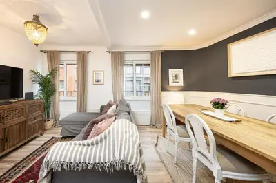 a living room with a table and a couch at Vintage 3 Bdr Apartment in Esplugues de Llobregat