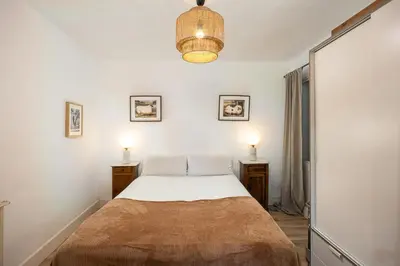 a bedroom with a large bed with two lamps at Vintage 3 Bdr Apartment in Esplugues de Llobregat