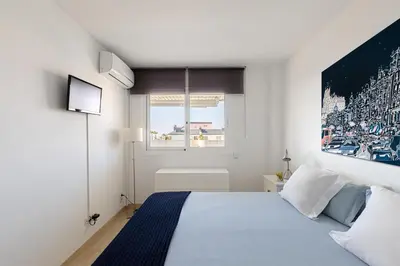 a bedroom with a bed with a large picture on the wall at Sitges ARENA - dos piscinas frente al mar in Sitges