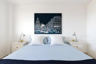 a bedroom with a blue bed with two night stands at Sitges ARENA - dos piscinas frente al mar in Sitges