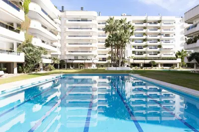 a swimming pool in front of a building at Sitges ARENA - dos piscinas frente al mar in Sitges
