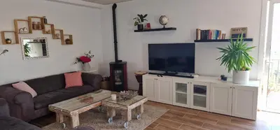 a table and chairs in a room with a large window at Villa Contenta Canyelles in Canyelles