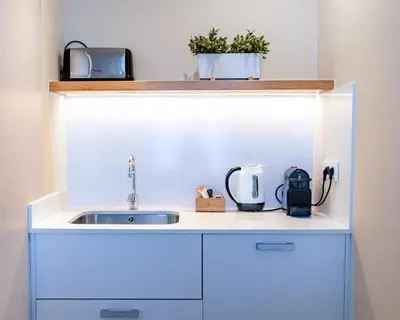 a kitchen counter with a sink and a appliance at Factory Apartments Barcelona in Barcelona