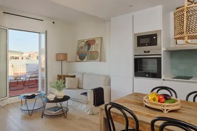a living room with a table and a couch at Factory Apartments Barcelona in Barcelona