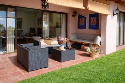 a patio with couches and a couch and grass at Villa Sitges Julia Vista Espectacular 2 k m s de la Playa Comoda & Area Tranquila Amplitud interior y plana in Sitges