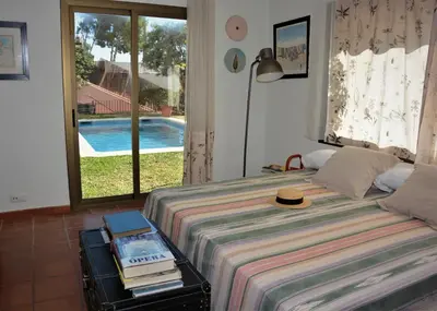 a bedroom with a bed with a hat on it at Villa Sitges Julia Vista Espectacular 2 k m s de la Playa Comoda & Area Tranquila Amplitud interior y plana in Sitges