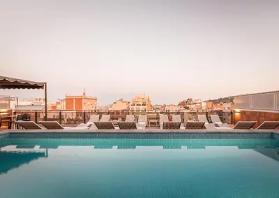 a swimming pool on the roof of a building at Petit Palace Eixample in Barcelona