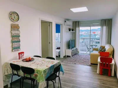 a room with a table and chairs and a living room at Magnifico Apartamento Barca 4 in Sant Adria de Besos