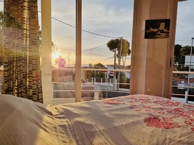 a bedroom with a window with a view of a ship at Casa con vistas al mar in Castelldefels