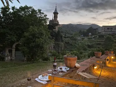 a table with food on it with a castle in the background at Romantic Stay in Grand Setting in Alella