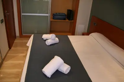 two towels on a bed in a hotel room at Apartaments Independencia in Barcelona