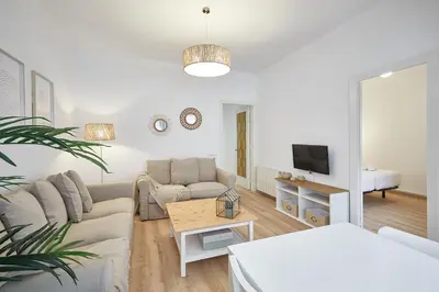 a living room with a couch and a table at BBarcelona Calabria Flat in Barcelona