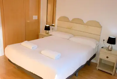 a bedroom with a large white bed with two pillows at SWEET BCN Rambla 48 in Barcelona