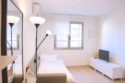 a bedroom with a bed and a tv and a mirror at SWEET BCN Plaza Universidad in Barcelona