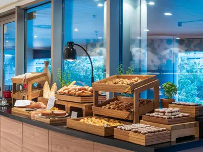 a bakery with many different types of pastries on display at Hilton Diagonal Mar Barcelona in Barcelona