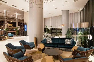 a lobby with a couch and chairs and a table at Hilton Diagonal Mar Barcelona in Barcelona