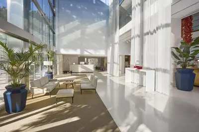 a room with white curtains and a dining room at Hilton Barcelona in Barcelona