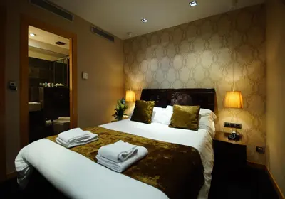 a hotel room with a large bed with towels on it at Casa Boutique Barcelona in Barcelona