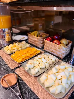 a table with plates of food and baskets of fruit at Ciudad de Castelldefels in Castelldefels