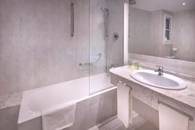 a bathroom with a tub and a sink and a shower at Ciudad de Castelldefels in Castelldefels