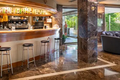 a bar at a restaurant with stools and a counter at Ciudad de Castelldefels in Castelldefels