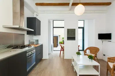 a kitchen with black cabinets and a white counter top at Gracia Terrace in Barcelona