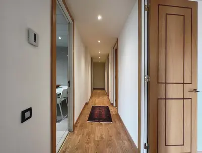 a hallway with a door and a rug on a floor at Stay Unique Apartments Diagonal III in Barcelona