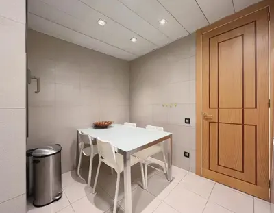 a dining room with a white table and white chairs at Stay Unique Apartments Diagonal III in Barcelona