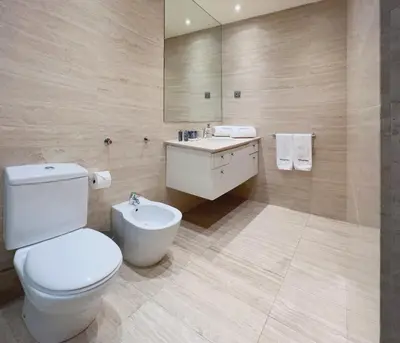a bathroom with a white toilet and a sink at Stay Unique Apartments Diagonal III in Barcelona