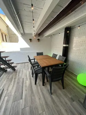 a conference room with a wooden table and chairs at Apartamento St Zenon in Arenys de Mar