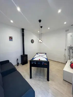 a living room with a pool table in a room at Apartamento St Zenon in Arenys de Mar